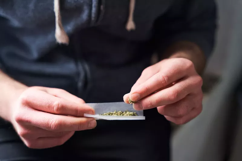 Image: Fingers rolling a joint