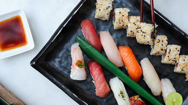 Sushi rolls on a black platter