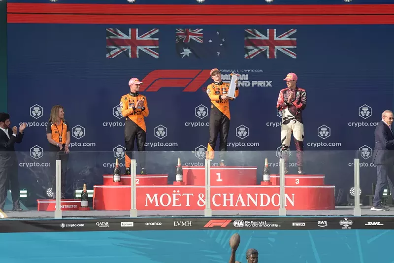 Image: Three F1 race car drivers on the podium