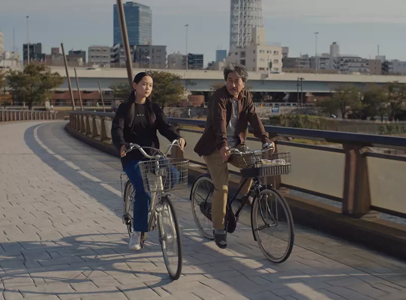 Image: Koji Yakusho and Arisa Nakano on bikes in the film Perfect Days