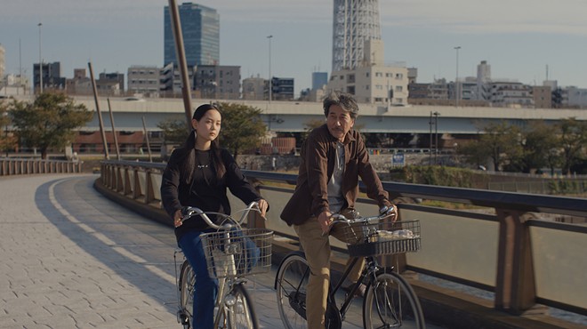 Koji Yakusho and Arisa Nakano on bikes in the film Perfect Days