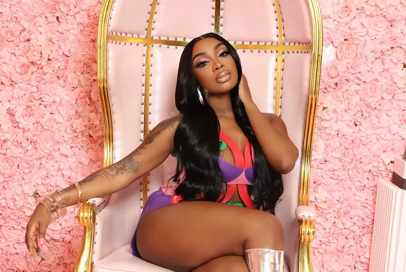 Image: iCandy sitting in a pink chair