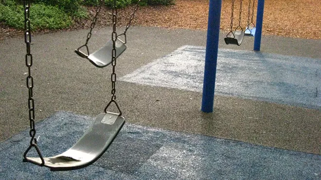 an empty swingset on a playground