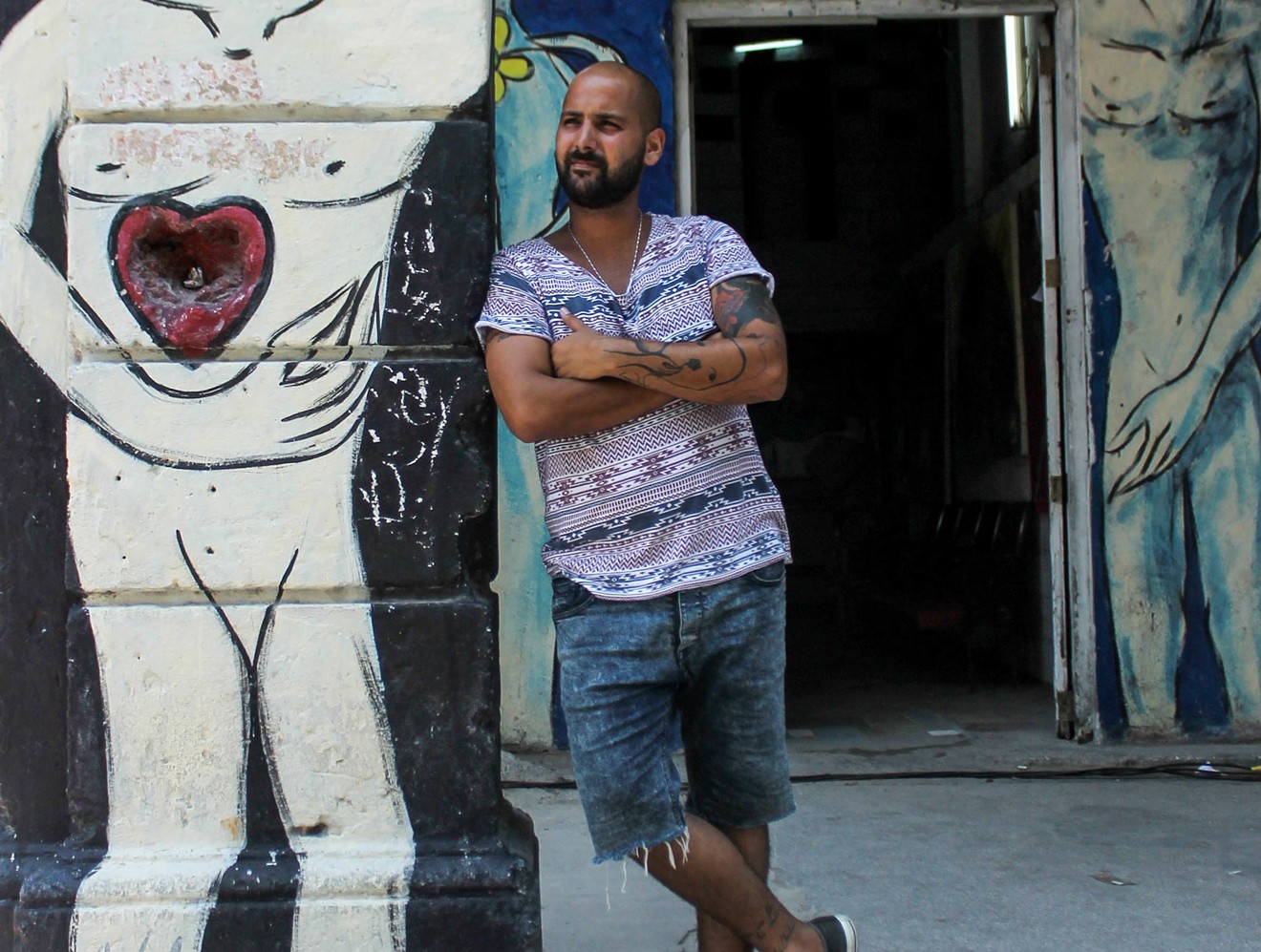Yulier Rodríguez Pérez stands in front of his studio in Havana.