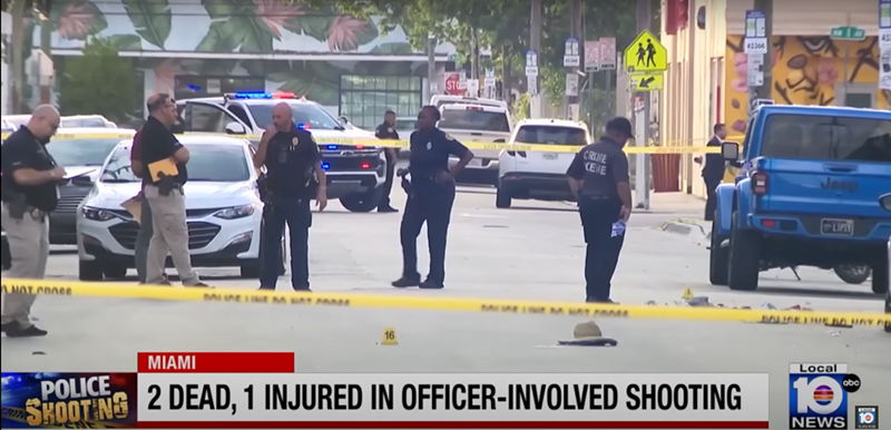 Image: A screenshot of a TV news report showing police officers standing around the crime scene in Wynwood.