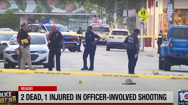A screenshot of a TV news report showing police officers standing around the crime scene in Wynwood.
