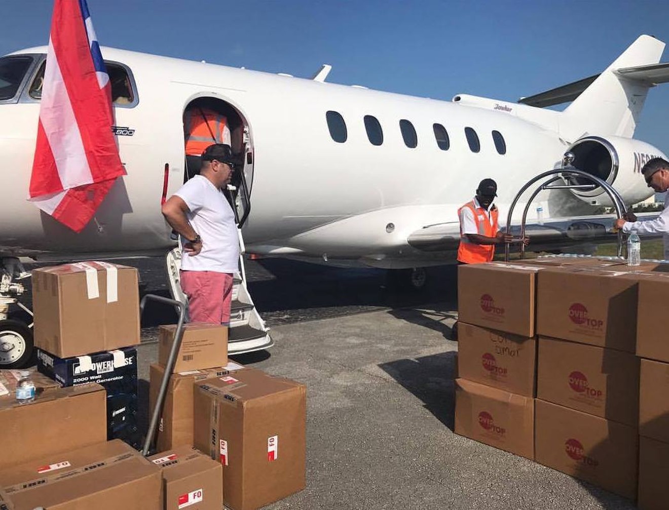 Volunteers load supplies for hurricane victims onto an airplane.
