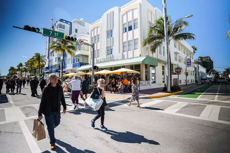 Image: People walking along Ocean Drive in Miami Beach in front of art deco buildings