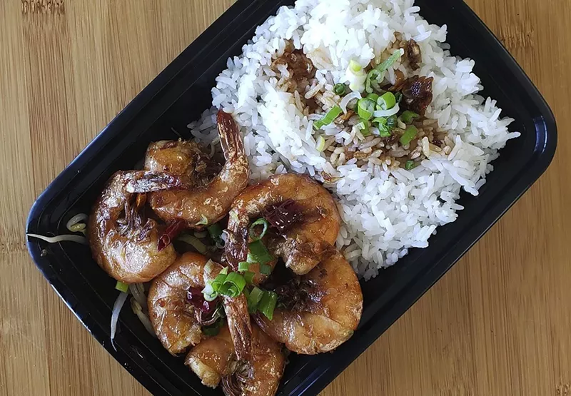 Image: Shell-on shrimp hold a savory sauce.