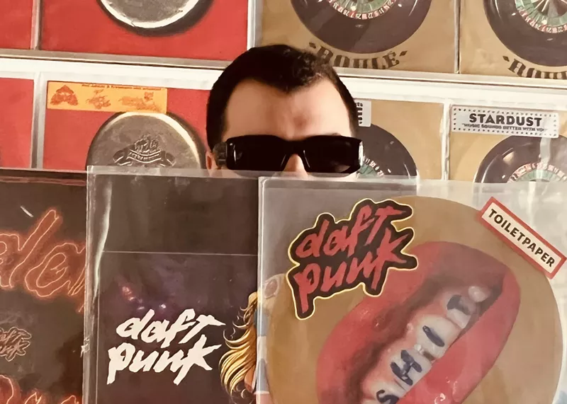 Image: Fruit Fly Records owner Giovanni Hanna poses with a few records from his Daft Punk collection.