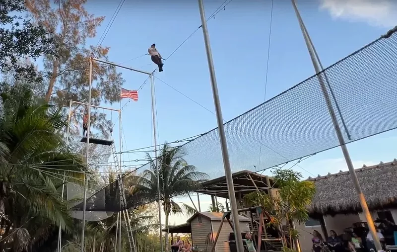 Image: Trapeze artists fly high in Miguel Quintero's backyard.