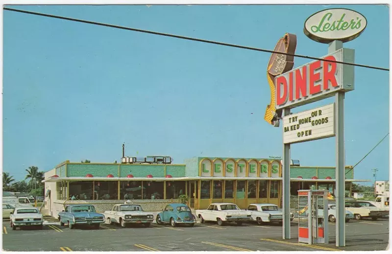 Image: a vintage photograph of a diner with cars parked out front in the parking lot from the 1960s or 1970s