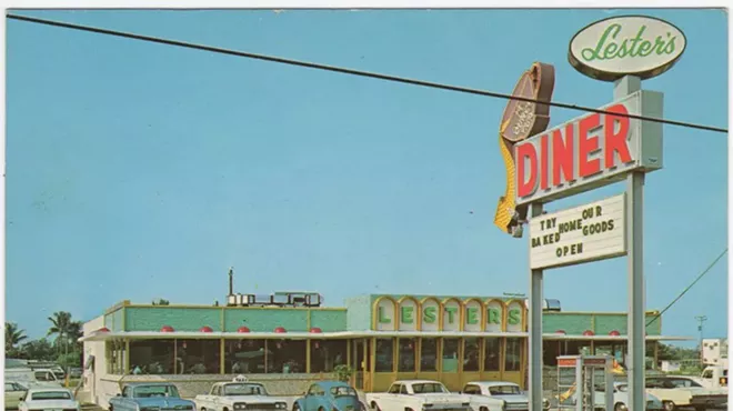 a vintage photograph of a diner with cars parked out front in the parking lot from the 1960s or 1970s