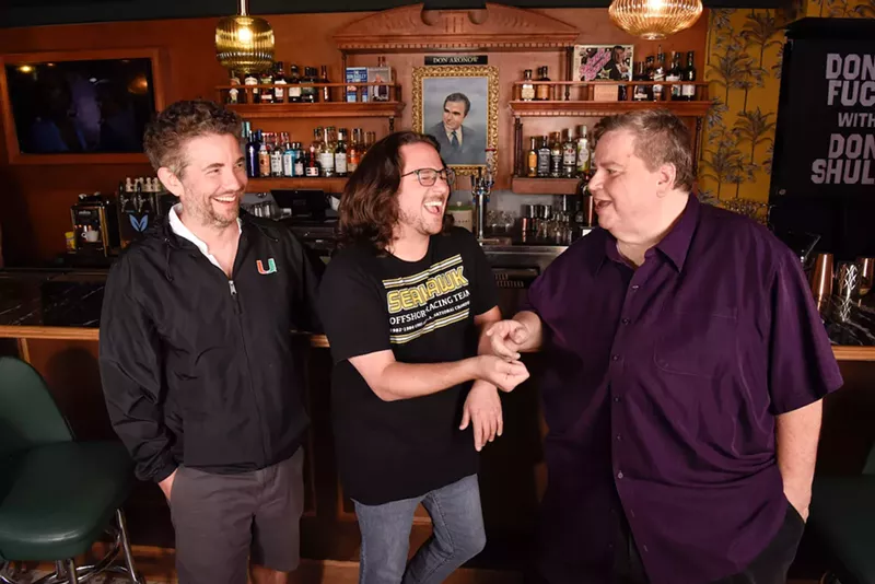 Image: As a portrait of the late powerboat racer Don Aronow gazes down from above Don’s Five Star Bar, Alfred Spellman, Billy Corben, and Jim DeFede reminisce about Miami’s days of blow and bought-off federal jurors.