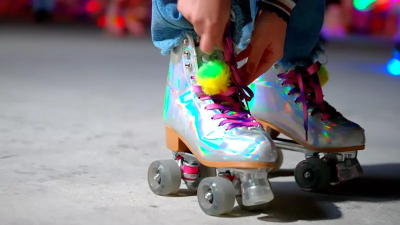 Image: close-up of a pair of iridescent roller skates