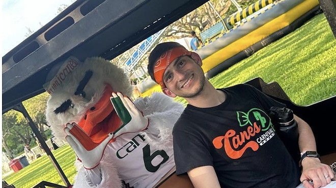 A photo of UM student Danny Bishop riding with a Hurricanes mascot