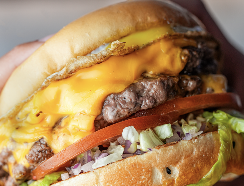 Image: A burger with toppings