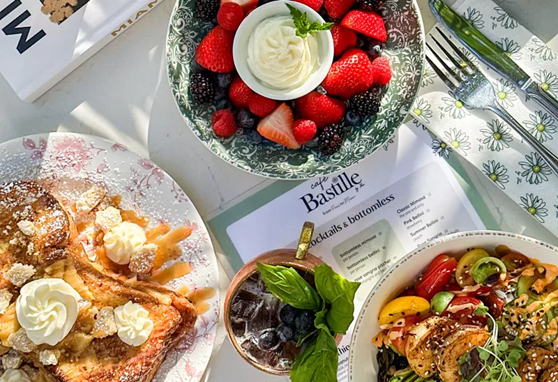 Image: Brunch food spread on a white table with colorful fruit