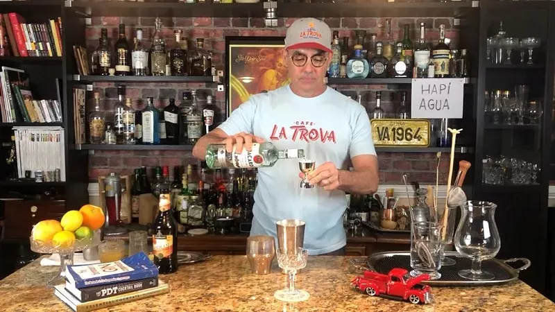 Image: Julio Cabrera mixes cocktails at his home bar.