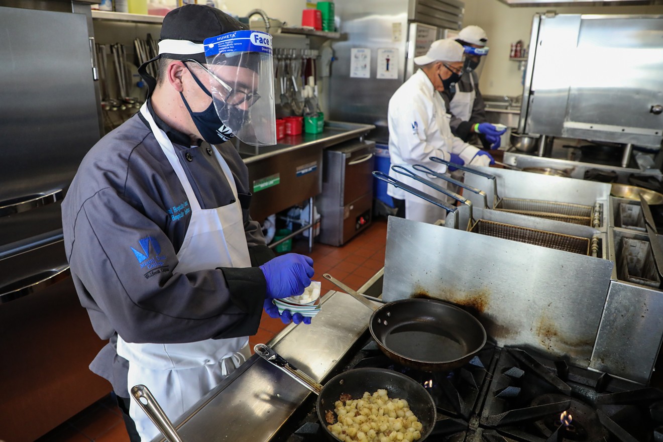 Student Ryan Walsh, foreground, works in the kitchen at Miami Dade College's Hospitality Institute.