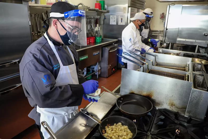 Image: Student Ryan Walsh, foreground, works in the kitchen at Miami Dade College's Hospitality Institute.