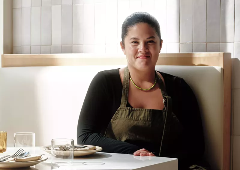 Image: A woman sitting at a table