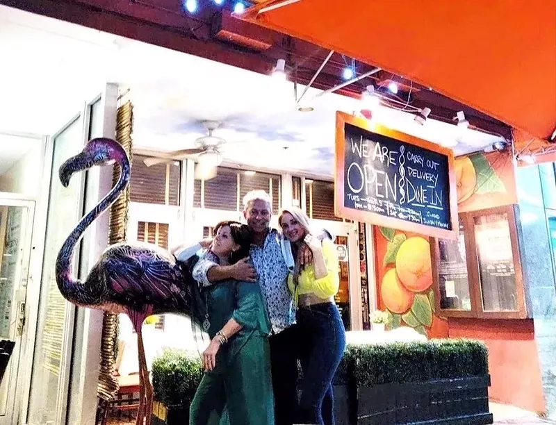 Image: From left: Flora the Flamingo, Cindy Hutson, Delius Shirley, and Ashley Hutson.