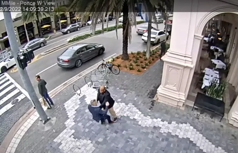 Image: A man identified as Miami police detective Stanley Paul-Noel (bald) tussles with Carlos "CJ" Gimenez outside Morton's the Steakhouse in Coral Gables as captured on the city's CCTV footage on February 9, 2022.