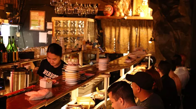 A dimly lit dining room with people