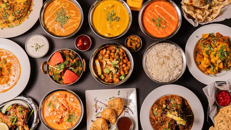 Image: Multiple Indian dishes in different bowls.
