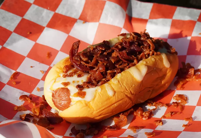 Image: A hot dog with toppings on paper