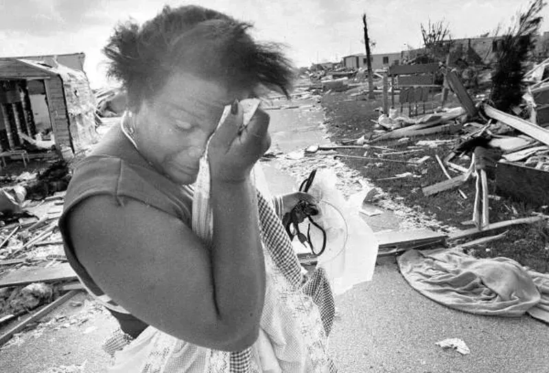 Image: A woman stands in the aftermath of Hurricane Andrew in 1992.