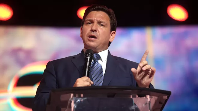 Florida Governor Ron DeSantis speaks at a podium at a Tampa, Florida, convention center