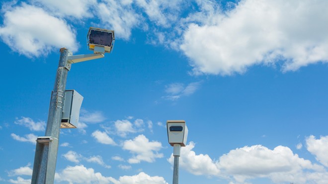 Speed cameras set against a blue sky