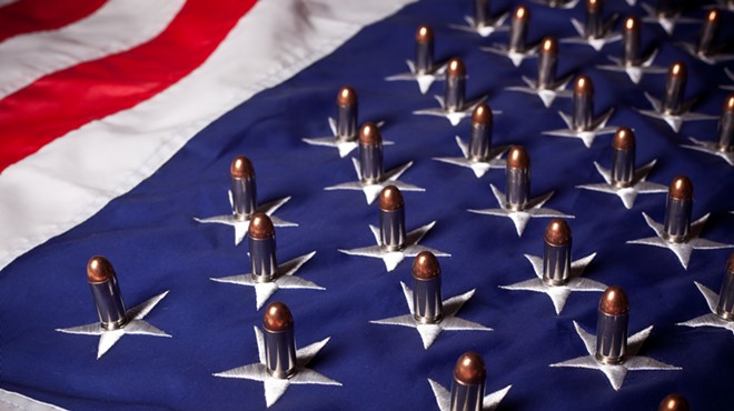 An American flag with bullets placed on each star