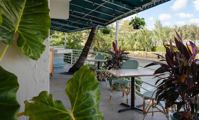 Image: The outside patio at Cafe Kush offers a peaceful waterfront respite off Biscayne Boulevard.