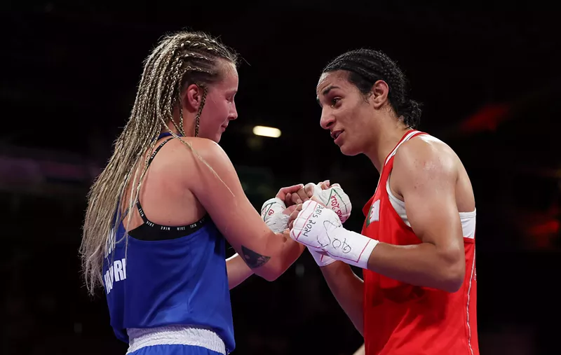 Image: Two Olympic boxers clasp hands in the ring