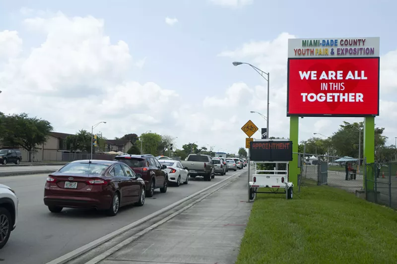 Image: Drivers wait in line for coronavirus testing at the Miami-Dade County fairgrounds.