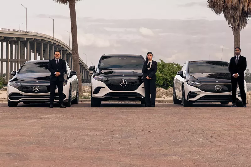 Image: Blacklane chauffeurs stand with a fleet of Mercedes EQS vehicles, ready to provide a seamless, on-demand luxury experience in Miami.