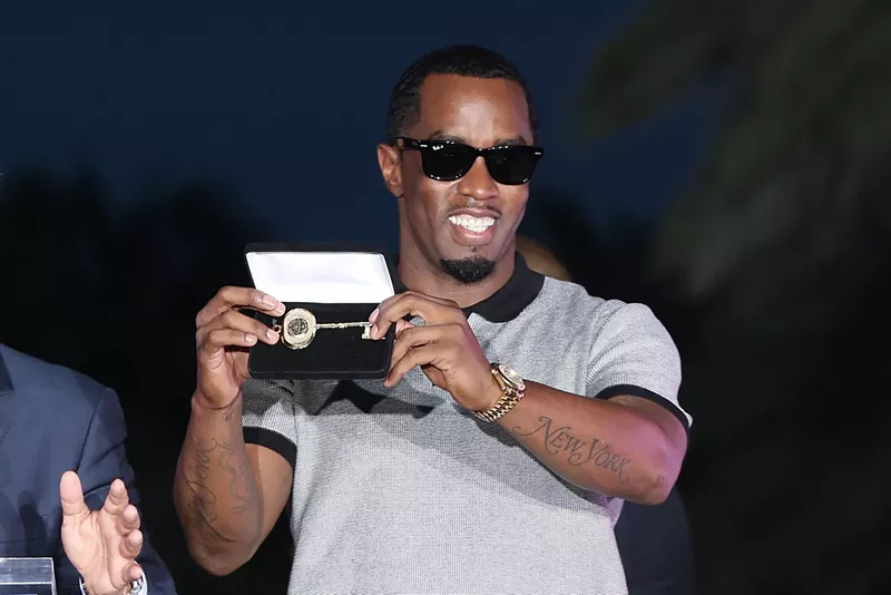 Image: Sean "Diddy" Combs" holding the key to the City of Miami Beach