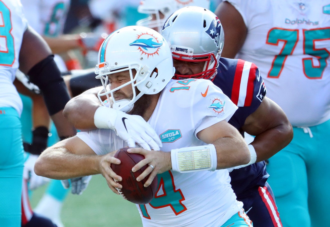 Derek Rivers of the New England Patriots sacks Miami Dolphins quarterback Ryan Fitzpatrick at Gillette Stadium.