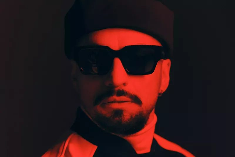 Image: Portrait of producer Dombresky bathed in a red light