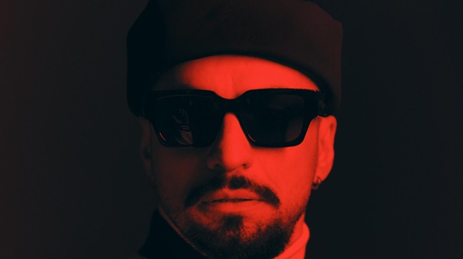 Portrait of producer Dombresky bathed in a red light