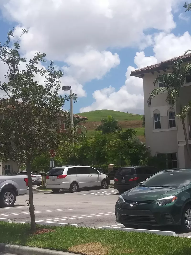Image: View of the Medley Landfill, AKA "Mount Trashmore," from the parking lot of the St. Maarten condo complex in Doral.
