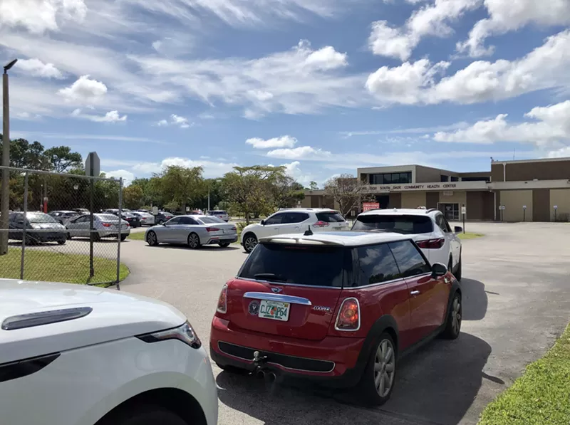 Image: Motorists wait in line for drive-thru coronavirus testing in Cutler Bay.