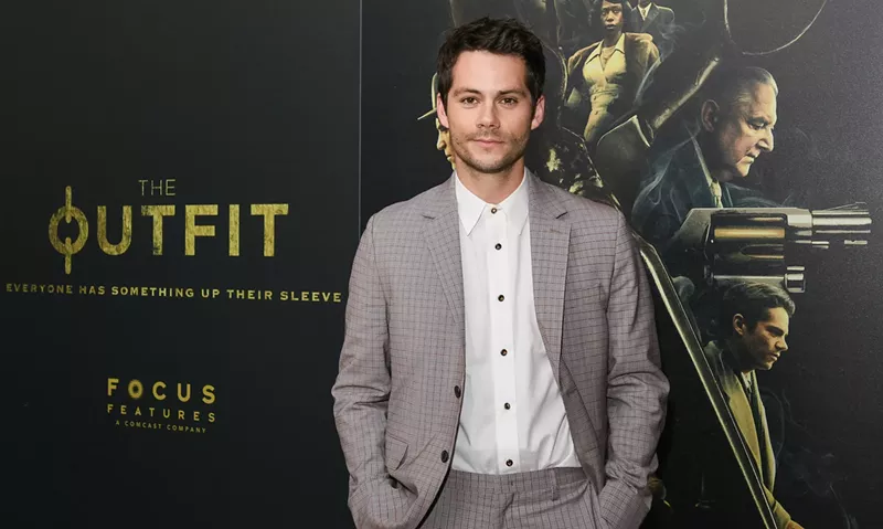 Image: Actor Dylan O'Brien wears a suit on a red carpet at a film premiere.