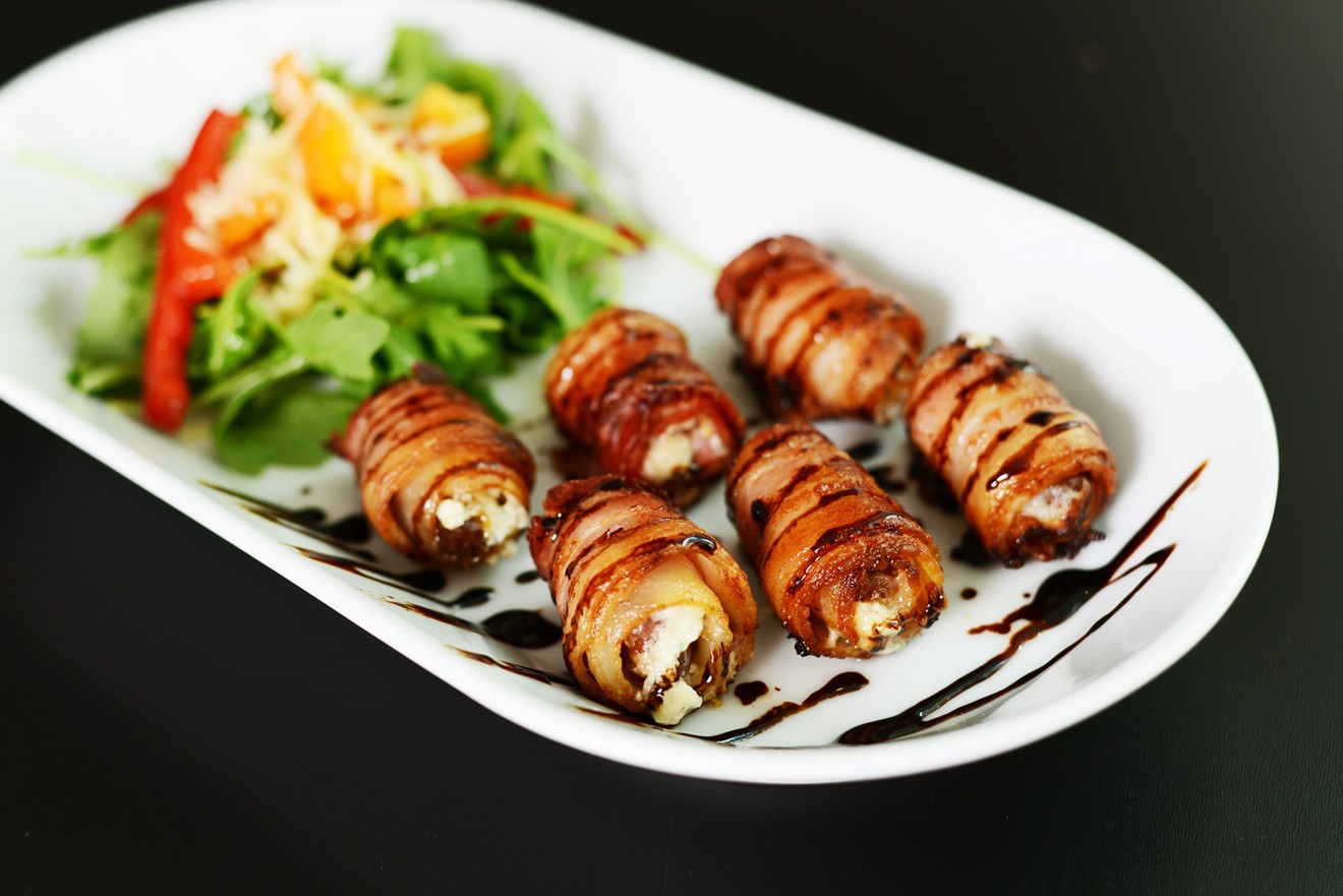 Bacon-wrapped Moroccan dates stuffed with goat cheese and mascarpone and drizzled with fig glaze.