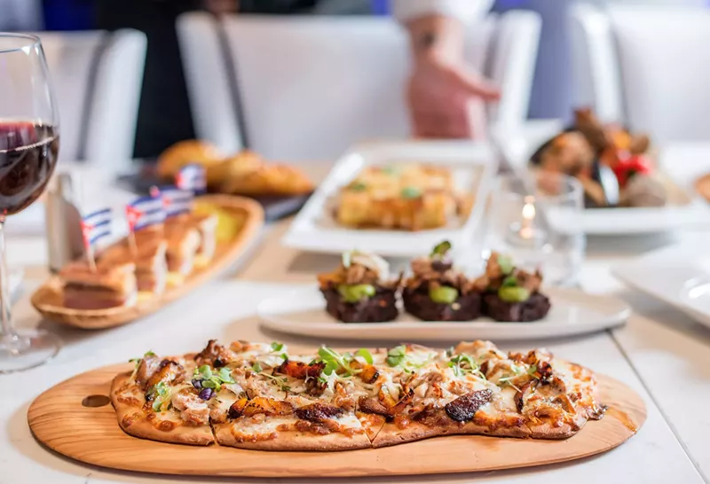 Image: Lechón-topped flatbread drizzled with truffle oil.