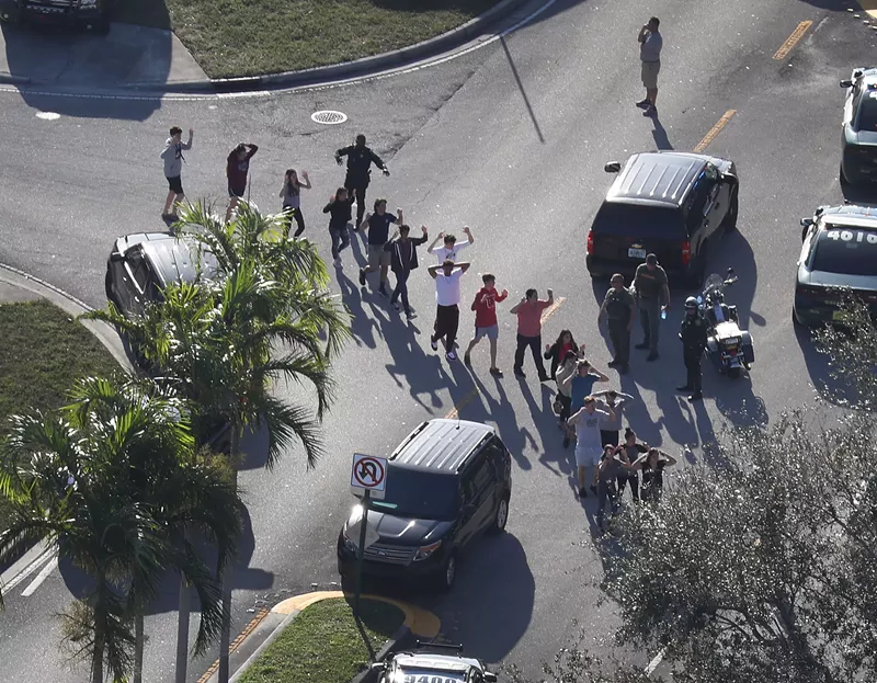 Image: Students are brought out of Marjory Stoneman Douglas High School in the aftermath of the February 2018 Parkland mass shooting.