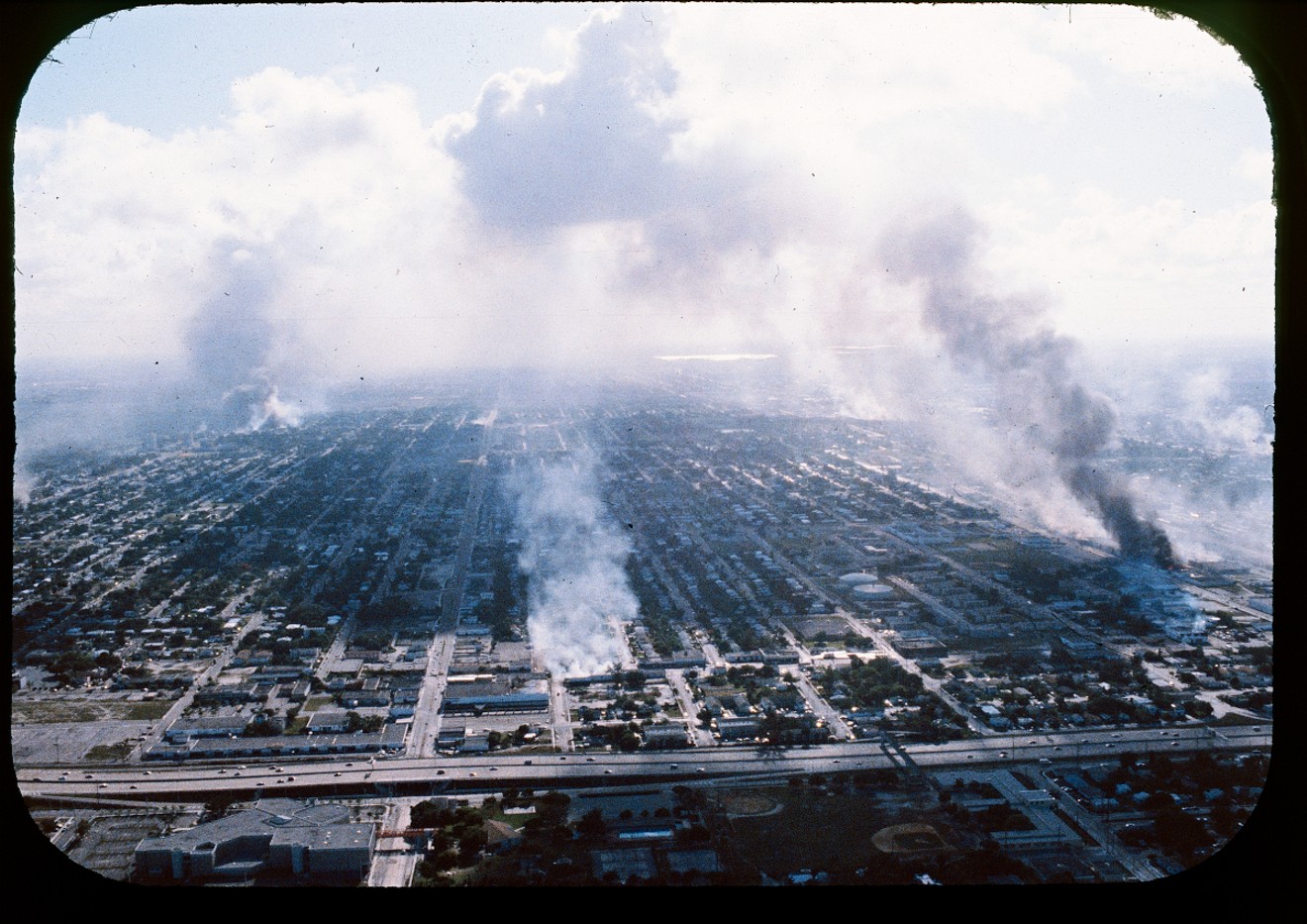 Aerial view looking west, showing columns of smoke in various parts of Miami during the McDuffie Riots, 1980.